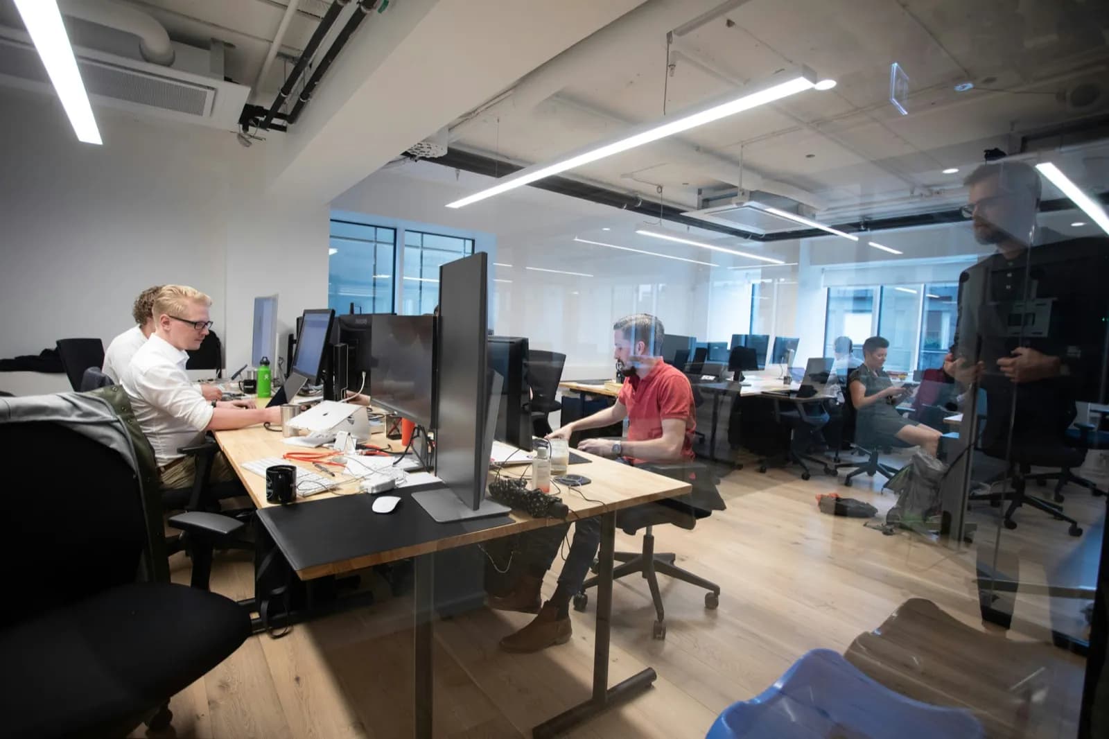 Udviklere og rådgivere fra VerifyID arbejder med eID- og identitetsløsninger i et moderne kontor